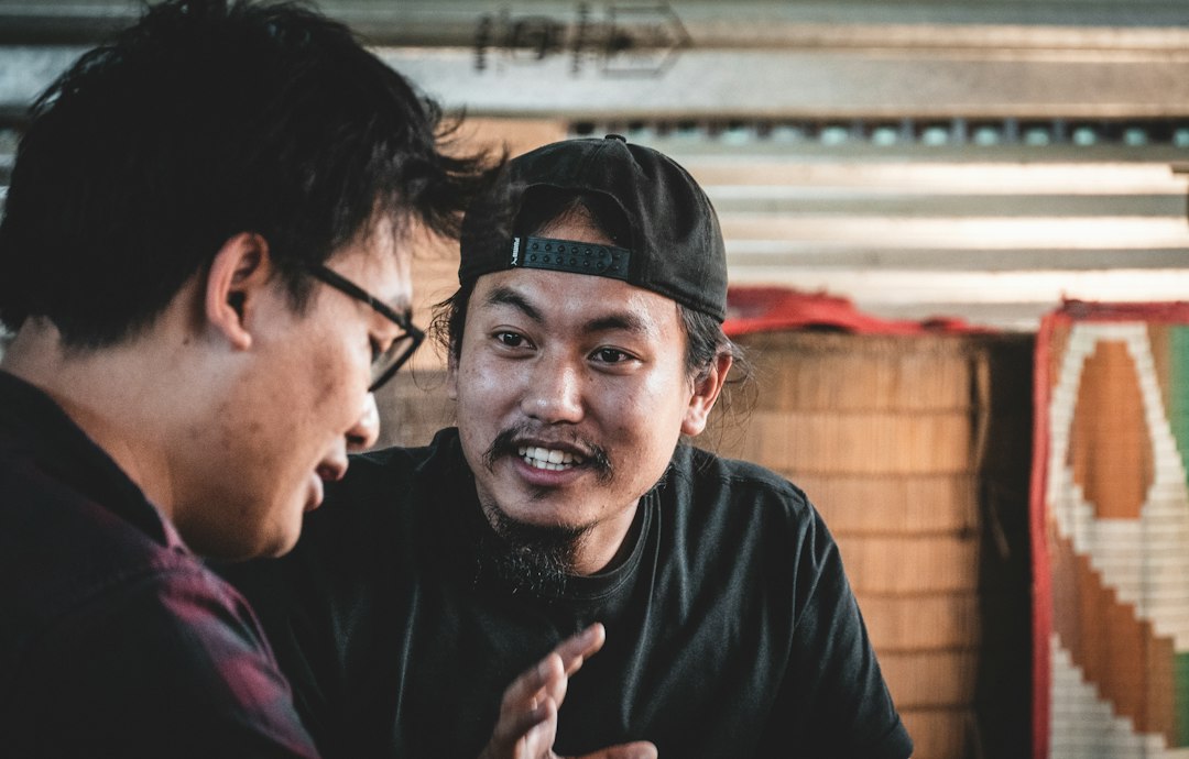 Two male business owners talking together in a shop; representative stock photography