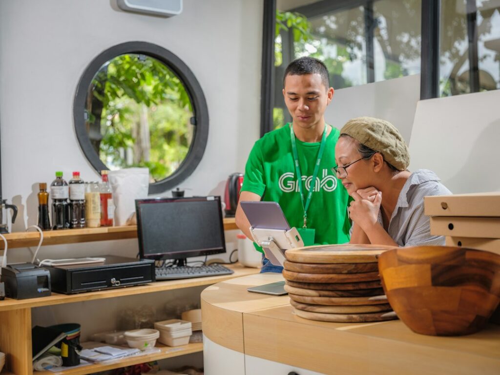 A man and a woman reviewing work together on a laptop