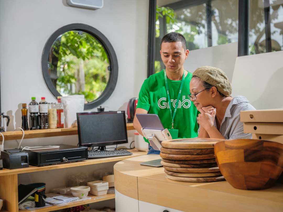 A man and a woman reviewing work together on a laptop